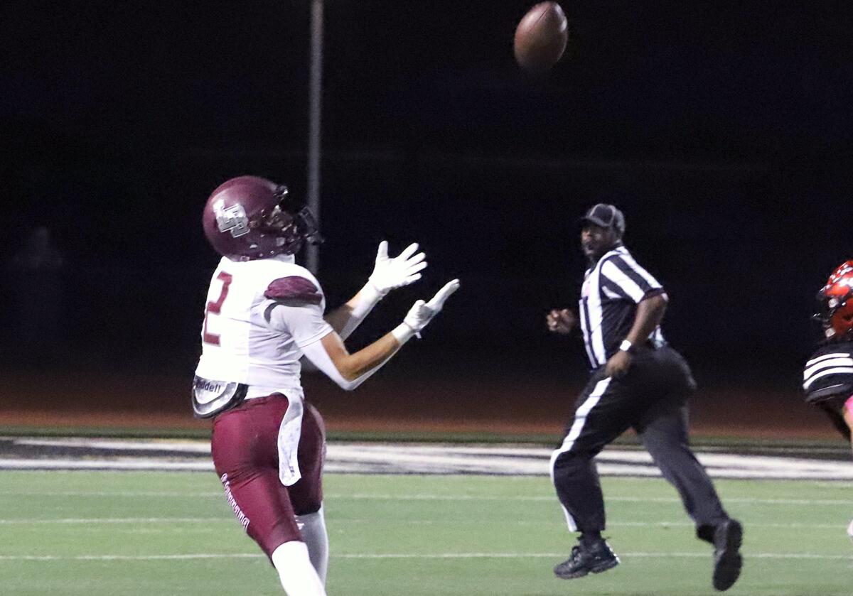 Laguna Beach's Chase Tyson (2) catches a pass from Jackson Kollock against Westminster on Friday.