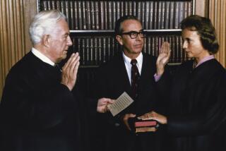 FILE - In this photo released by the White House, Justice Sandra Day O'Connor, the first female justice of the Supreme Court, is sworn in by Chief Justice Warren Burger in the court's conference room in Washington, Sept. 25, 1981. Justice O'Connor's husband John holds two family Bibles. O'Connor, who joined the Supreme Court in 1981 as the nation's first female justice, has died at age 93. (AP Photo/The White House, File)