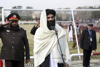FILE - Taliban acting Interior Minister Sirajuddin Haqqani speaks during a graduation ceremony at the police academy in Kabul, Afghanistan, Saturday, March 5, 2022. A rare public show of division has arisen in the ranks of Afghanistan's ruling Taliban. A senior Taliban figure publicly criticized the group's leadership in a speech, accusing some of monopolizing power. The comments by Interior Minister Sirajuddin Haqqani were seen as directed at the Taliban's supreme leader, Haibatullah Akhundzada. (AP Photo, File)