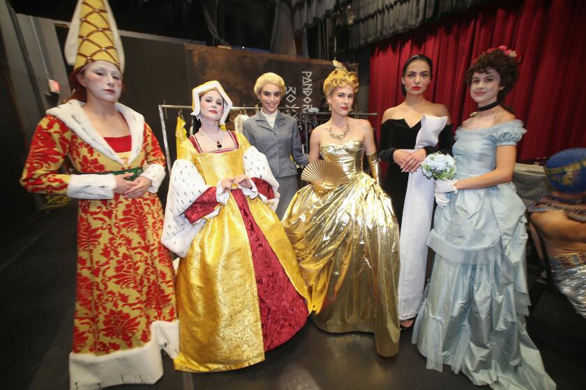 Cast members prepare for the opening act for the "A La Mode: The Art of Fashion."