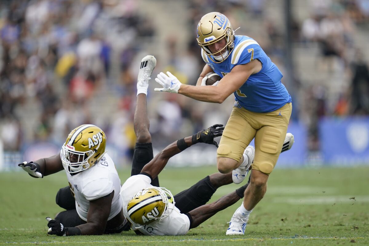 UCLA wide receiver Colson Yankoff runs the ball against Alabama State defenders.