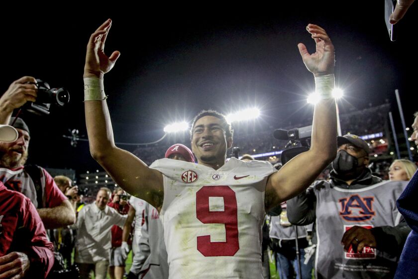 FILE - Alabama quarterback Bryce Young (9) celebrates after defeating Auburn in an NCAA college football game Saturday, Nov. 27, 2021, in Auburn, Ala.. (AP Photo/Butch Dill, File)