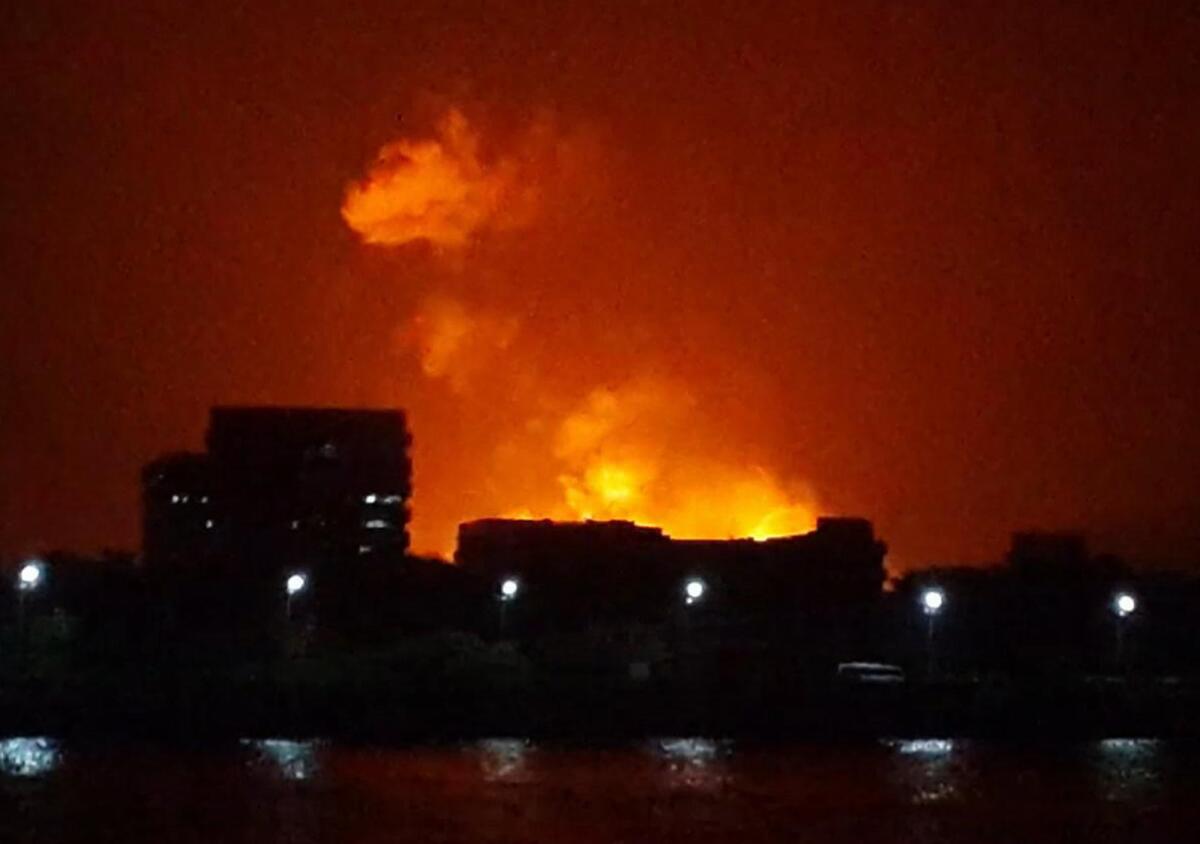 The night sky is lit up as a fire burns aboard the Sindhurakshak, an Indian navy submarine in Mumbai.