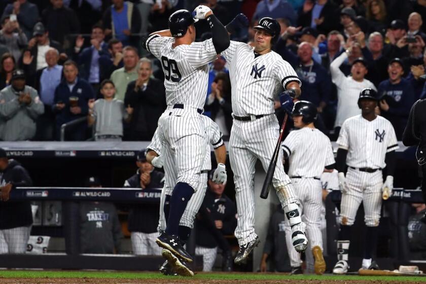 NEW YORK, NY - OCTOBER 03: Aaron Judge #99 of the New York Yankees celebrates with teammate Gary Sanchez #24 after hitting a two run home run against Jose Berrios #17 of the Minnesota Twins during the fourth inning in the American League Wild Card Game at Yankee Stadium on October 3, 2017 in the Bronx borough of New York City. (Photo by Al Bello/Getty Images) ** OUTS - ELSENT, FPG, CM - OUTS * NM, PH, VA if sourced by CT, LA or MoD **