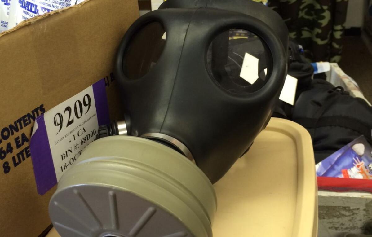Gas masks sit on a merchandise table near the door of Uncle Sam's Safari Outfitters, a military surplus store in Manchester, Mo. The shop cannot keep up with the demand for masks after several nights of violent protests in Ferguson during which police have deployed tear gas.
