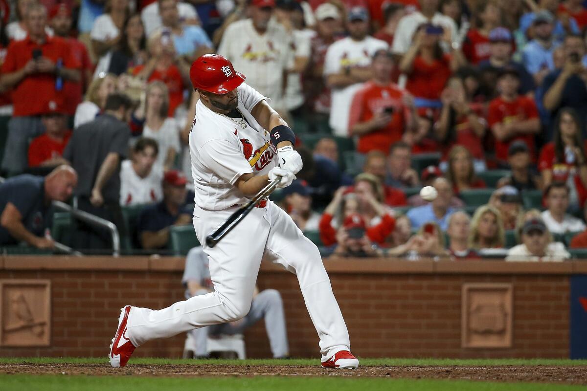St. Louis Cardinals' Albert Pujols hits a two-run home run during the sixth inning of a baseball game against the Cincinnati Reds, Friday, Sept. 16, 2022, in St. Louis. (AP Photo/Scott Kane)