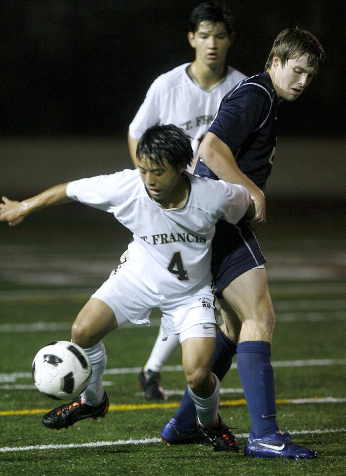 St. Francis High's #4 Luke Hatanaka battles for the ball with Crescenta Valley High's #22 Matt Ryan during play in the Ralph Brandt Tournament at St. Francis High School in La Canada Flintridge on Saturday, December 1, 2012.