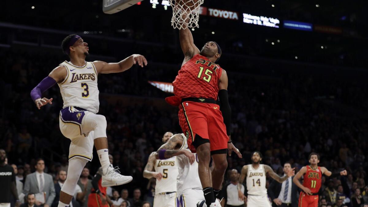 The Atlanta Hawks' Vince Carter dunks next to the Lakers' Josh Hart during a Nov. 11 game at Staples Center.