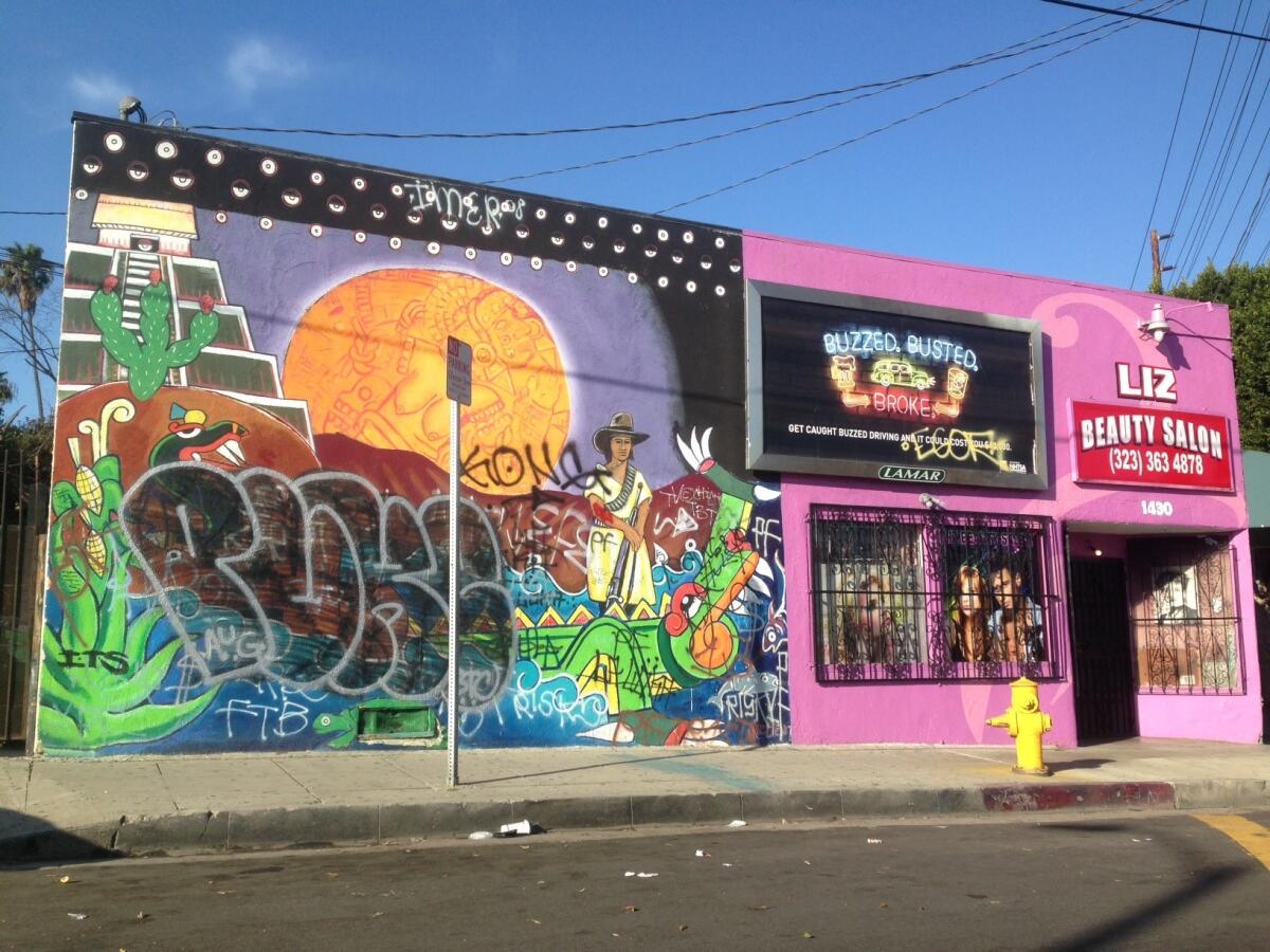 A mural in Boyle Heights marred by graffiti.