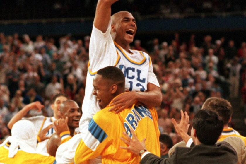 Ed O'Bannon is lifted into the air by teammate Ike Nwankwo after the Bruins defeated Arkansas in the NCAA championship game in Seattle.