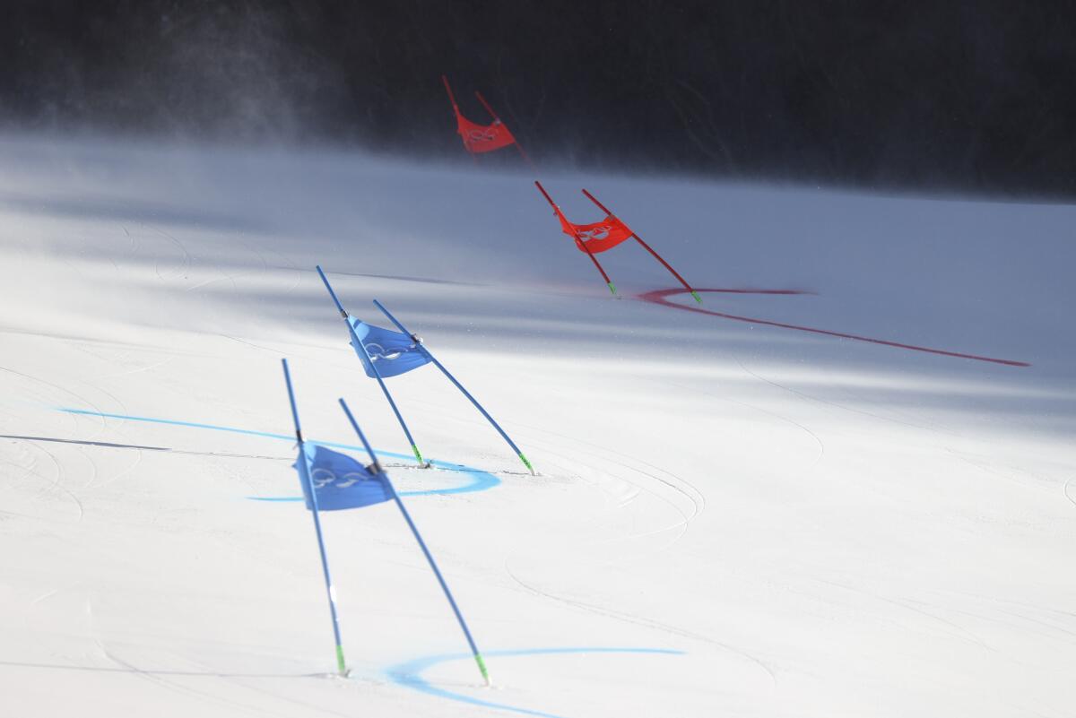Gate flags bend after high winds caused a delay in the start of the mixed team parallel skiing event 