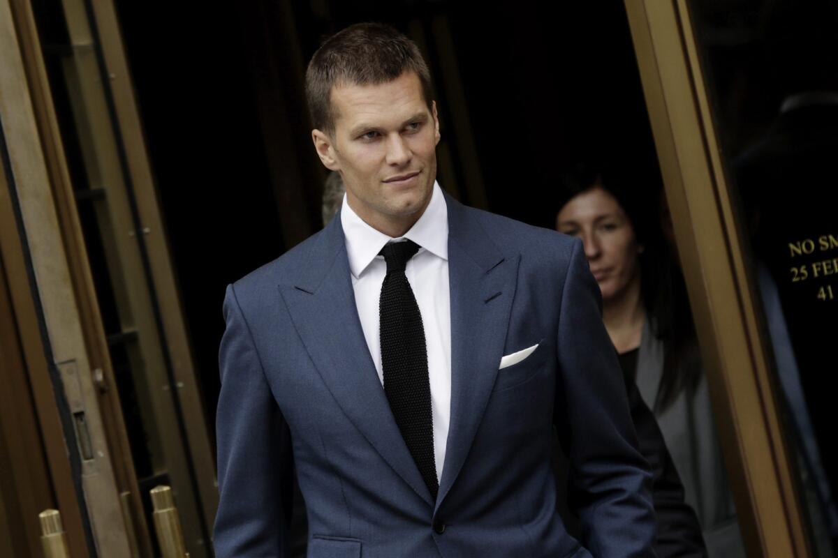 New England quarterback Tom Brady leaves court after a hearing Monday in New York City.
