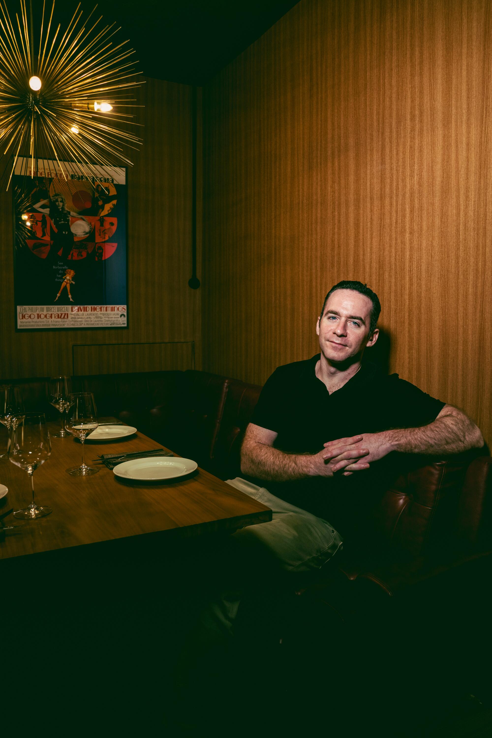 A man sits at a table at a restaurant 