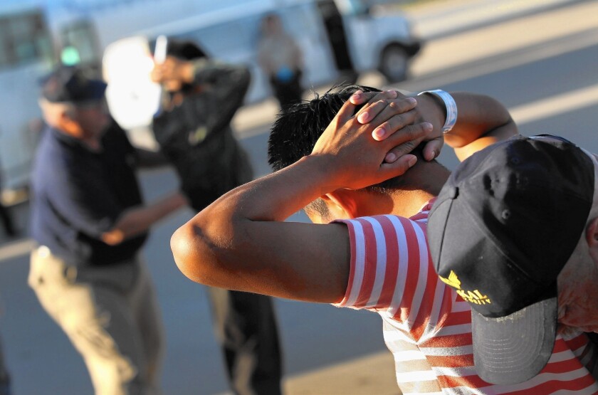 Guatemalan immigrants who were in the country illegally are body-searched at an airport in Mesa, Ariz., before being deported to Guatemala City in 2011.