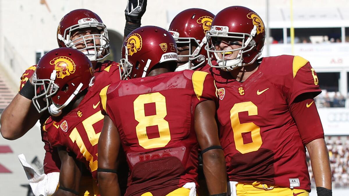 USC quarterback Cody Kessler, right, celebrates with his teammates after throwing a first-quarter touchdown pass in the Trojans' win over Fresno State last week.