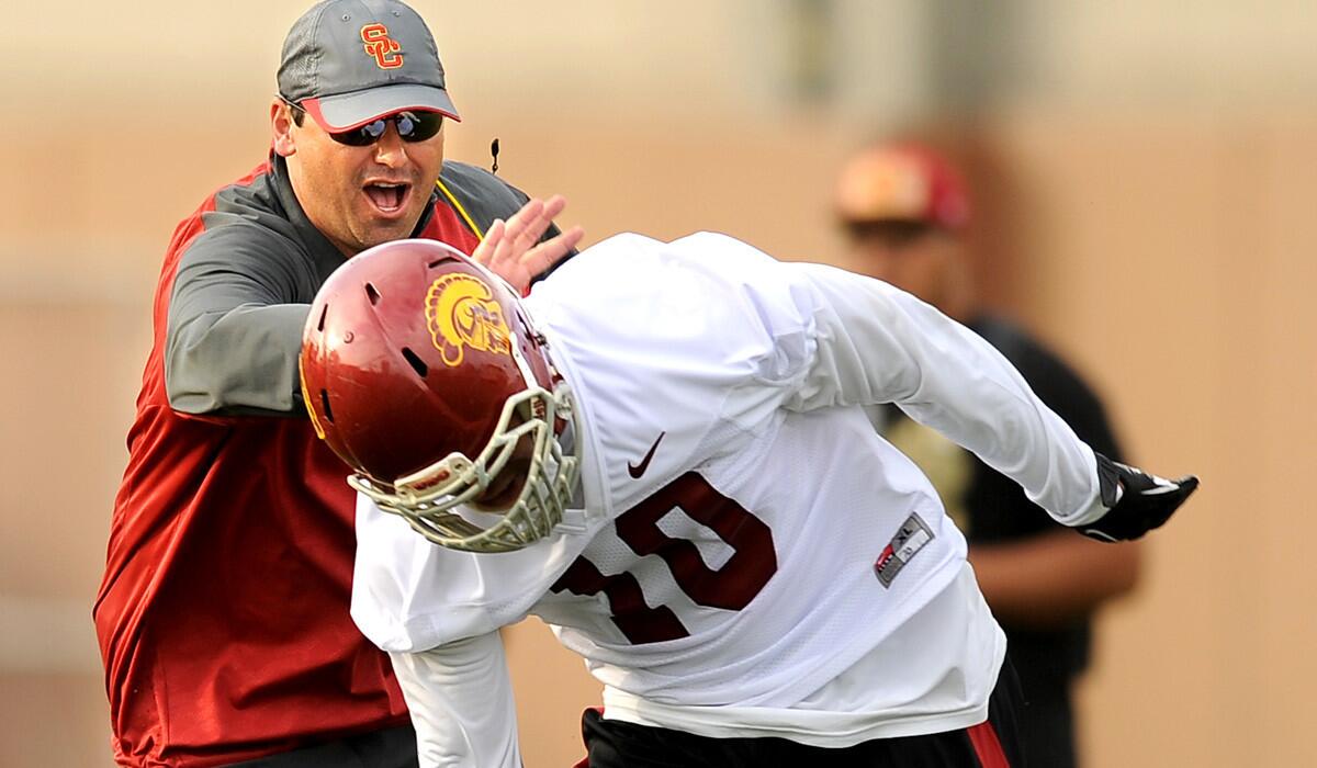 USC Coach Steve Sarkisian works with linebacker Hayes Pullard during spring practice.