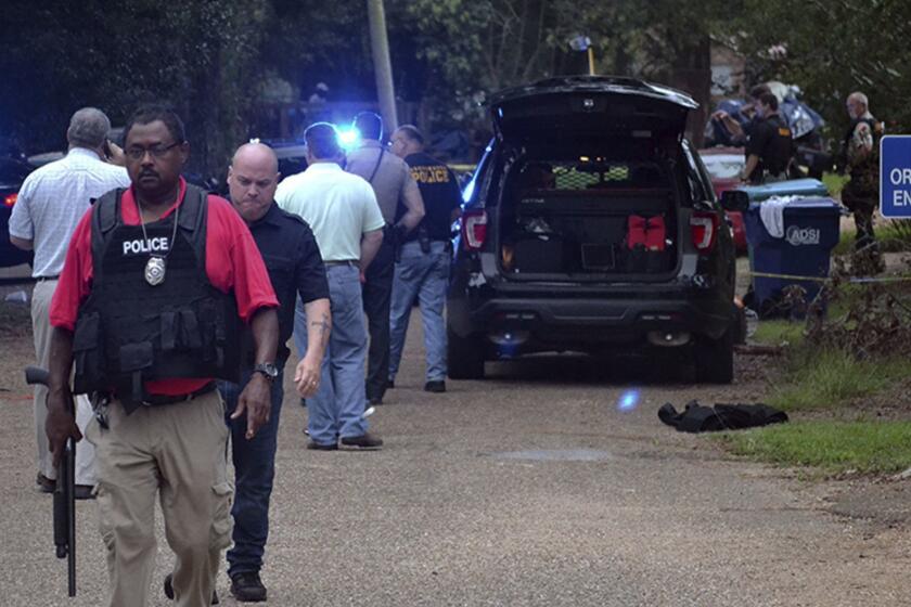 Law enforcement agents secure the scene of a shooting in Brookhaven, Miss., where two police officers were killed Saturday morning, Sept. 29, 2018. A suspect was wounded and was taken into custody. (Donna Campbell/The Daily Leader, via AP)