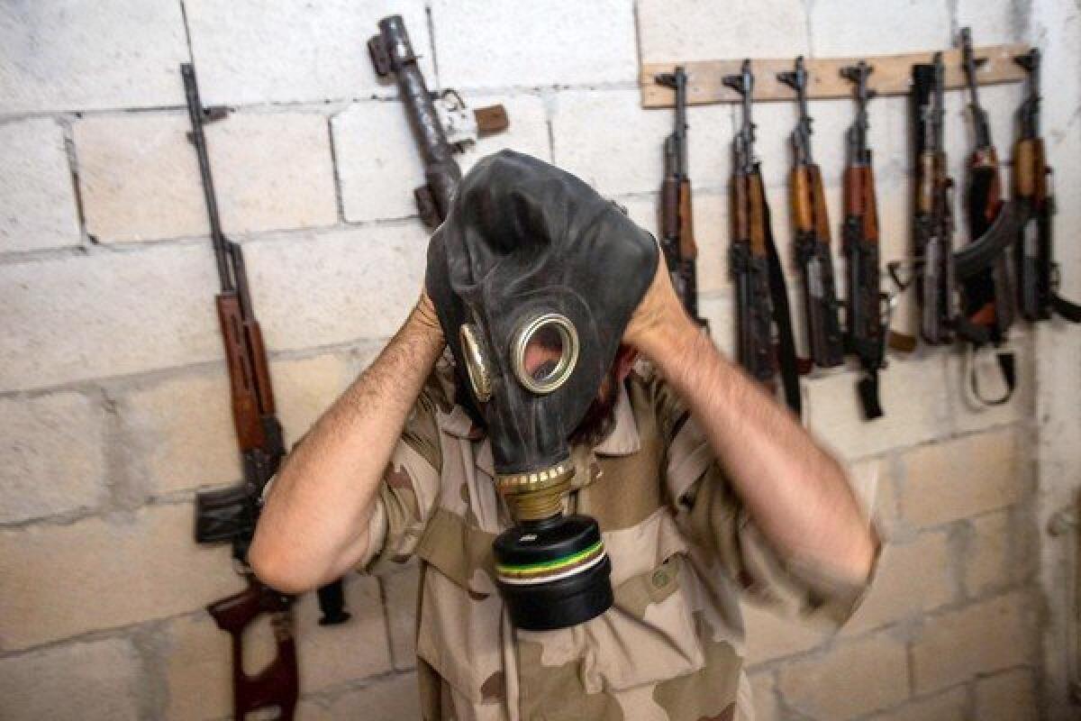 A Syrian rebel tries on a gas mask seized from an army factory in the northwestern province of Idlib. The United States is weighing a military strike against Bashar Assad's regime for an alleged chemical weapons attack on civilians.