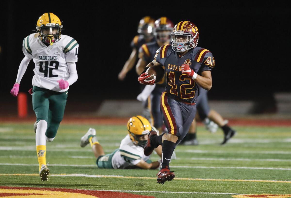 Estancia's Josh Romero (42) gets loose into the open field for a big gain during an Orange Coast League football opener.