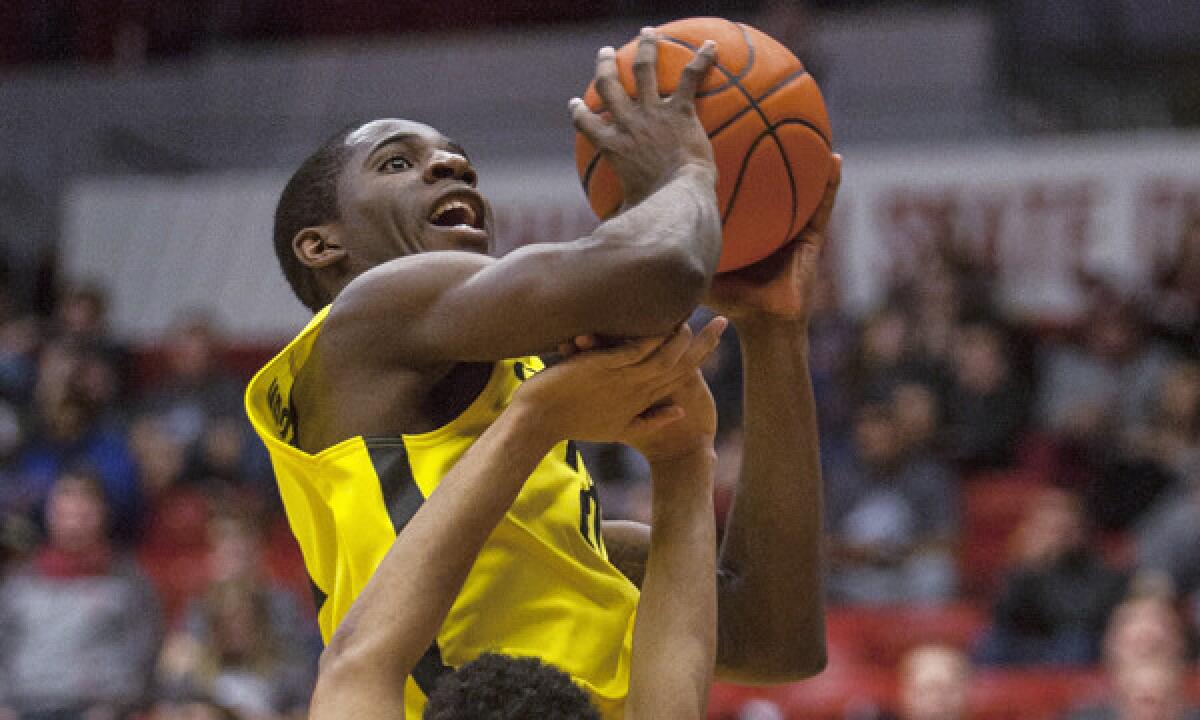 Oregon forward Mike Moser puts up a shot during the second half of the Ducks' 71-44 win over Washington State on Sunday. A controversial NCAA transfer rule has given Moser the opportunity to play at Oregon despite having played and graduated from Nevada Las Vegas.