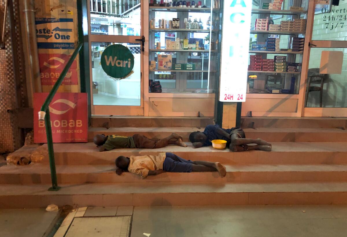 Talibes sleeping in a shopfront in Touba.