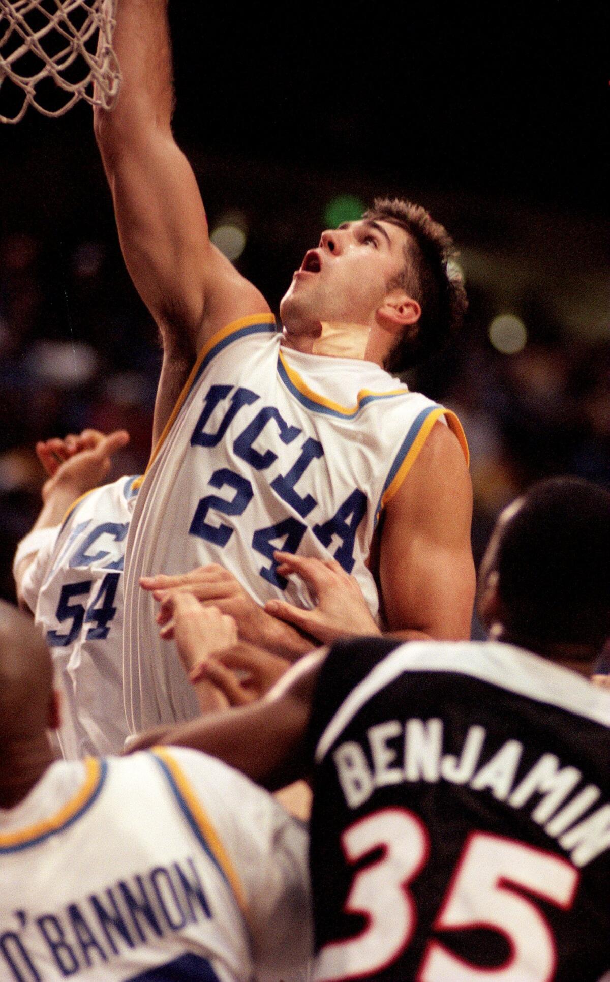 UCLA's Bob Myers reaches for a rebound during a basketball game against Oregon State.