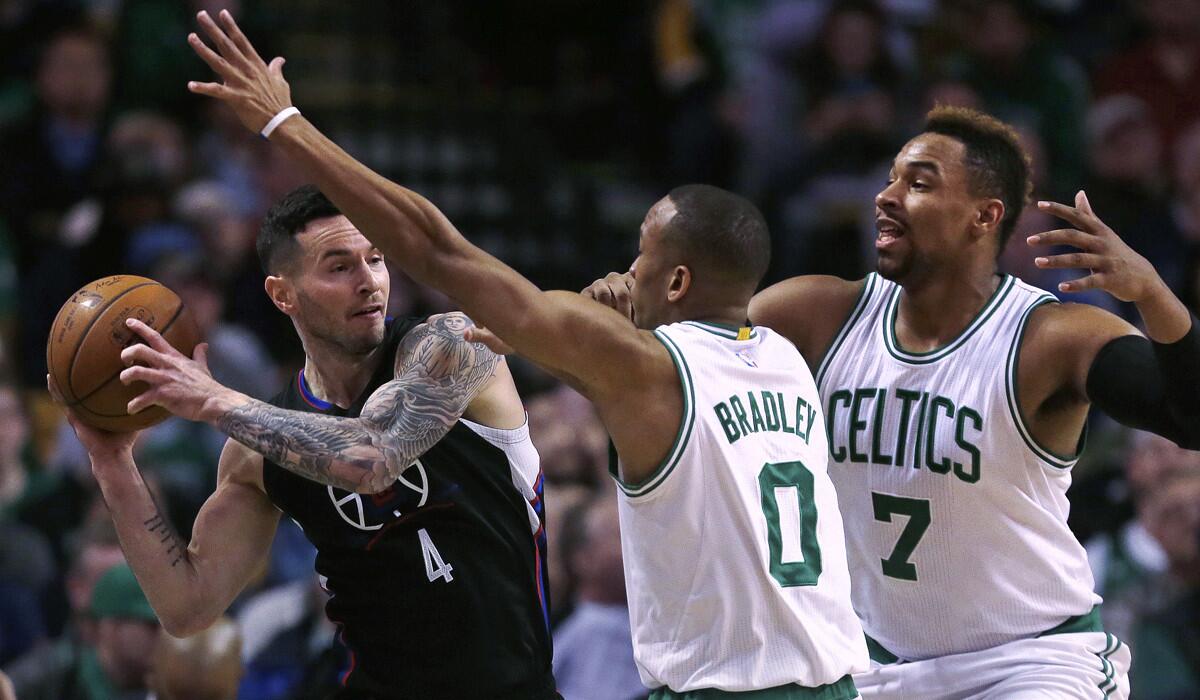 Los Angeles Clippers guard J.J. Redick (4) is trapped by Boston Celtics guard Avery Bradley (0) and center Jared Sullinger (7) during the first quarter on Wednesday.