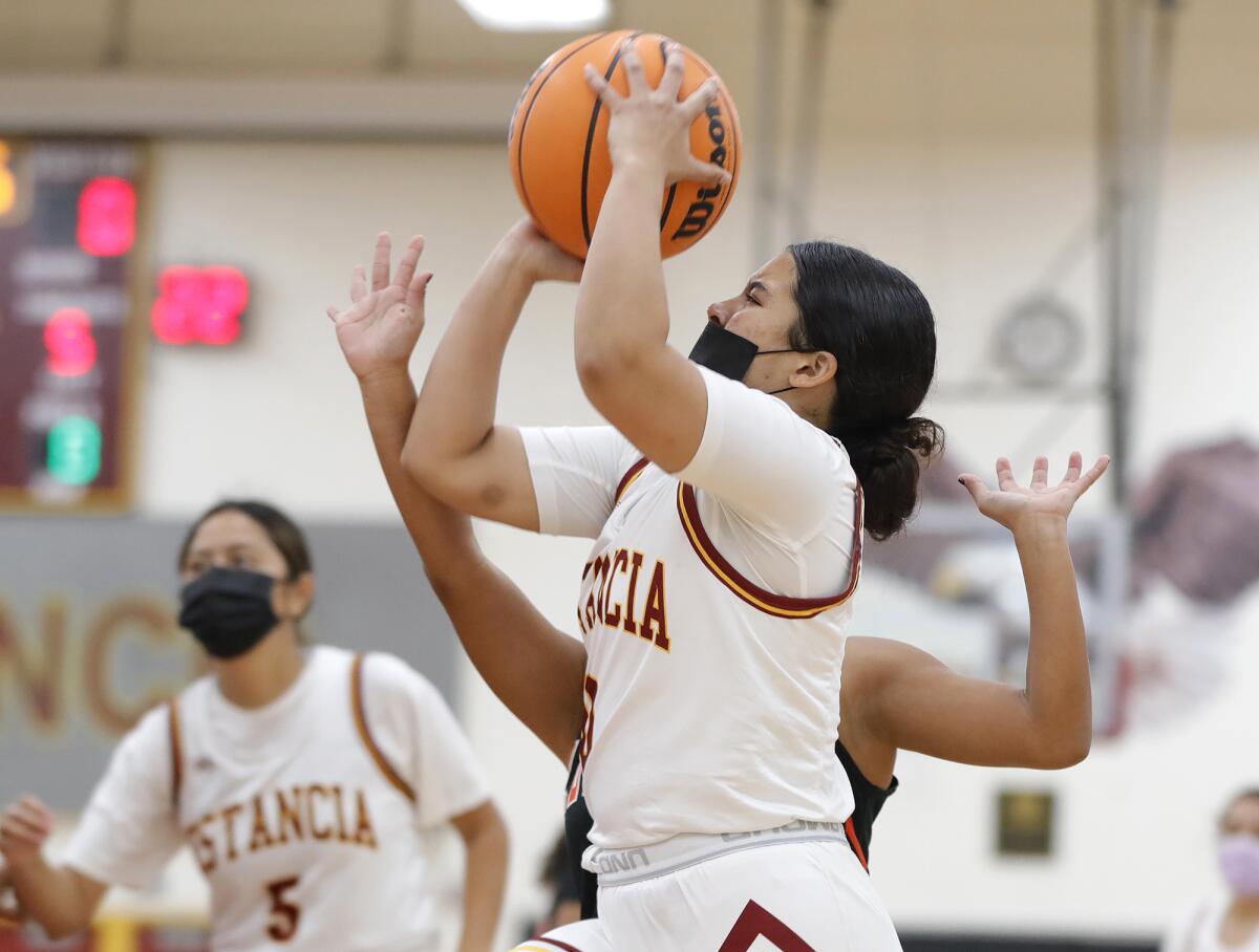 Mackenzie Sanchez drives in for a layup during a girls' basketball game against Los Amigos on Dec. 23.