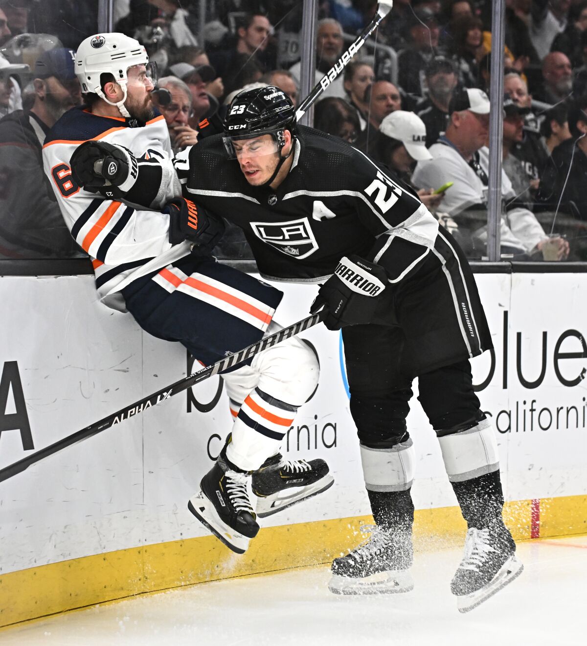 Dustin Brown checks Edmonton's Kris Russell into the boards.