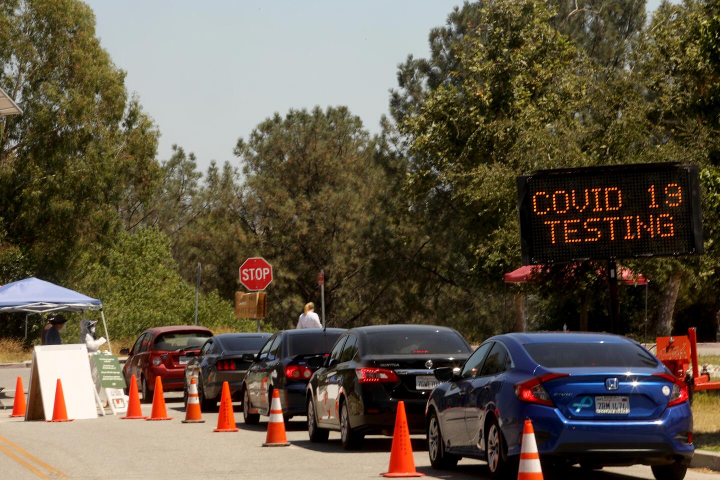 Cars wait in line at the Hansen Dam testing site in Sylmar.