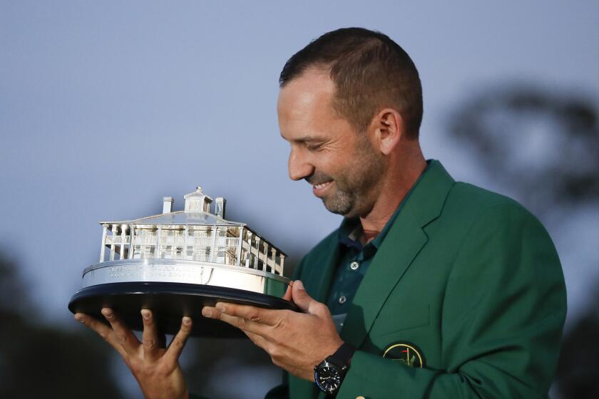 Sergio Garcia admires the winner's trophy during the awards ceremony following his victory at the Masters.