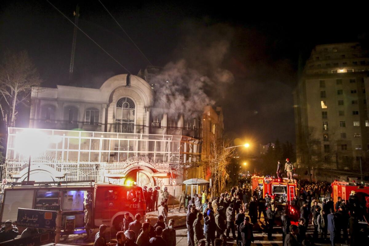 Smoke rises as Iranian protesters set fire to the Saudi embassy in Tehran.