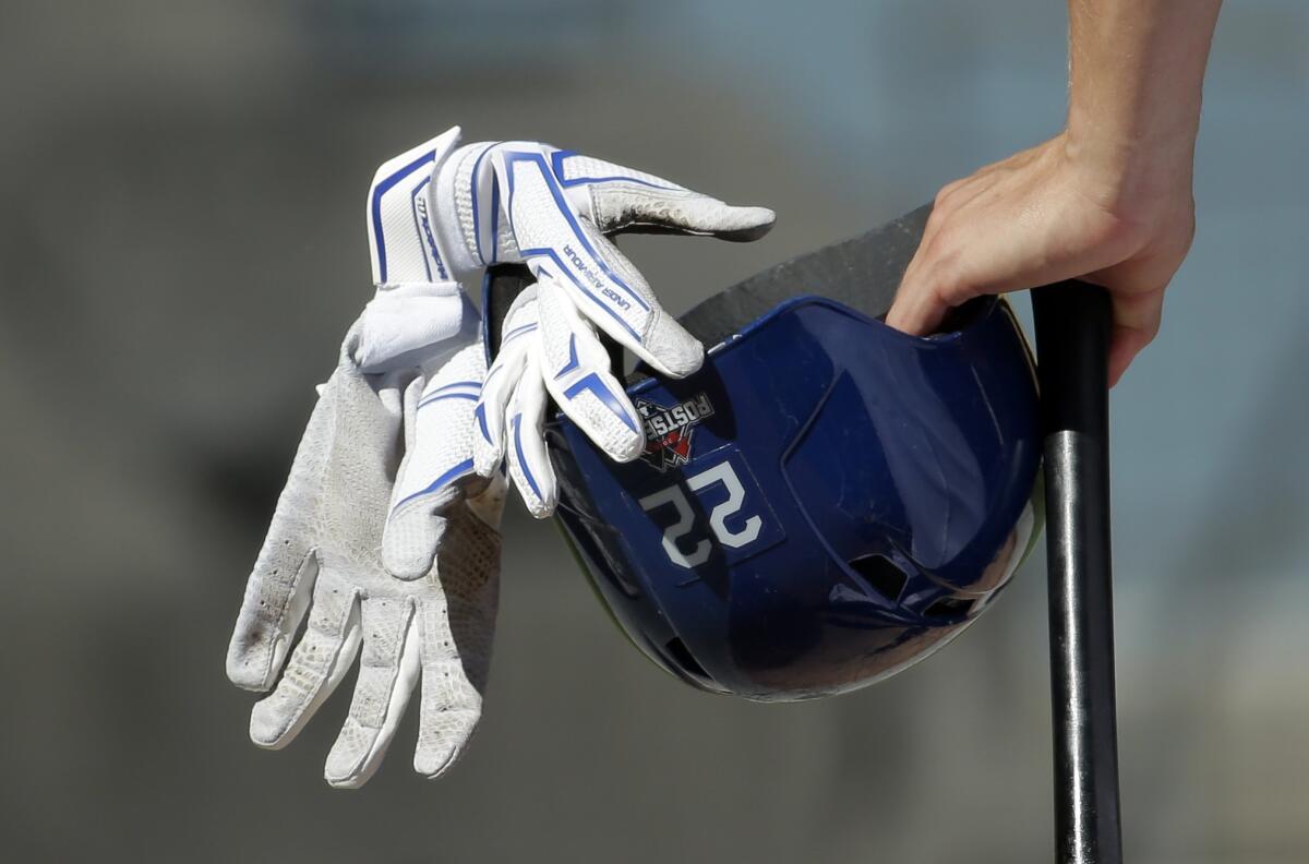 Clayton Kershaw leans on his bat during a workout on Thursday.