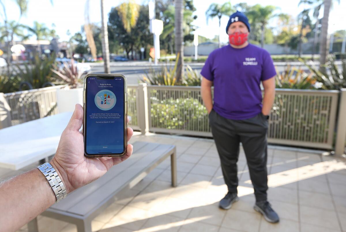 Danny Wexler shows how many miles he's walked that day on his Fitbit fitness tracker.