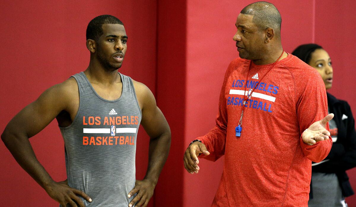 Clippers Coach Doc Rivers talks to point guard Chris Paul during training camp in Las Vegas on Sept. 30.