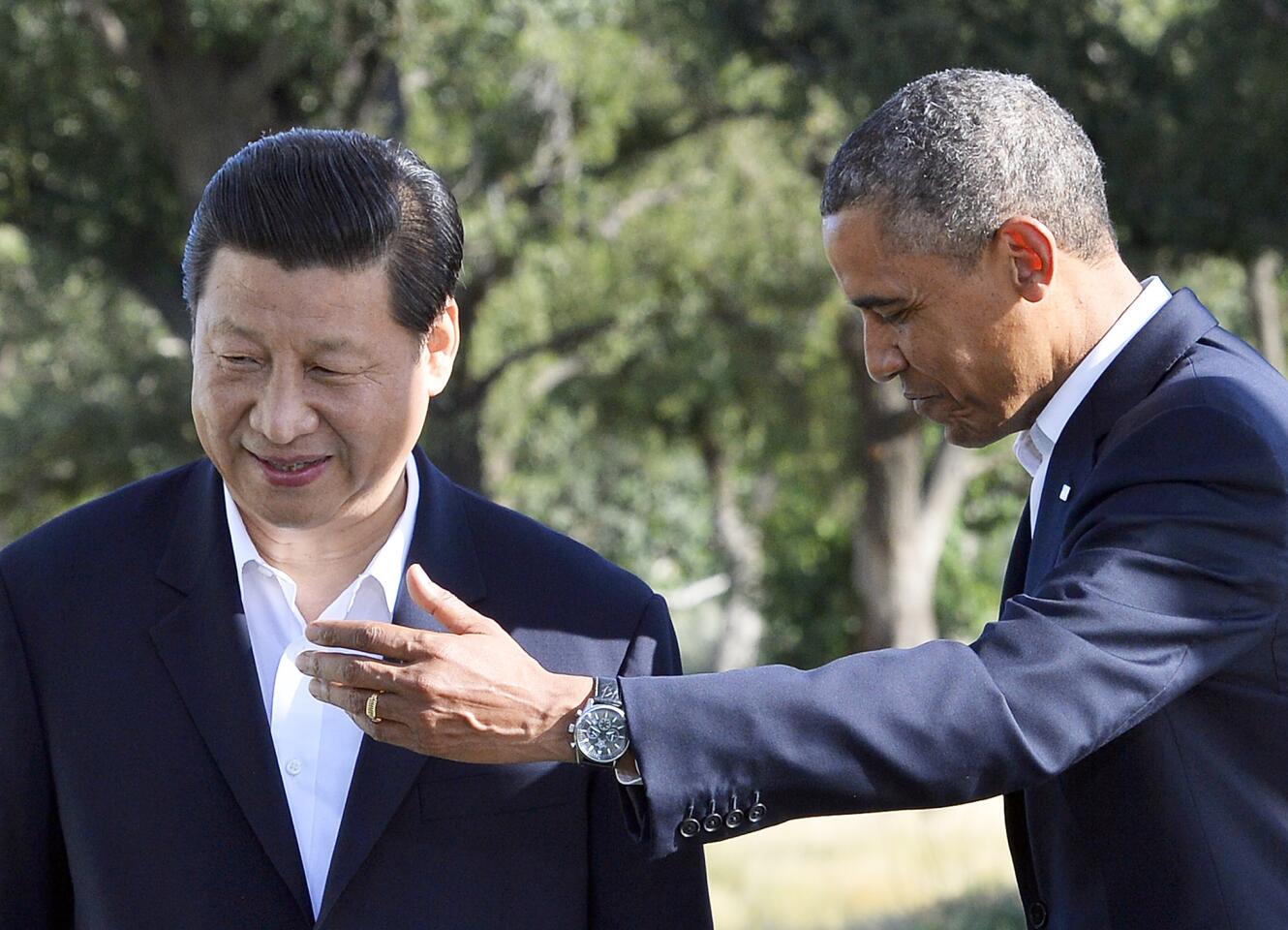 US President Barack Obama and Chinese President Xi Jinping head for their bilateral meeting at the Annenberg Retreat at Sunnylands in Rancho Mirage, California, on June 7, 2013. Ditching the crushing formality of US-China summits, Xi and Obama met in Rancho Mirage, California, a playground of past presidents and the powerful. Allegations of Chinese cyber hacking and espionage, North Korea's nuclear defiance and constant trade niggles between the world's two single largest economies and possible future superpower rivals will dominate the talks.