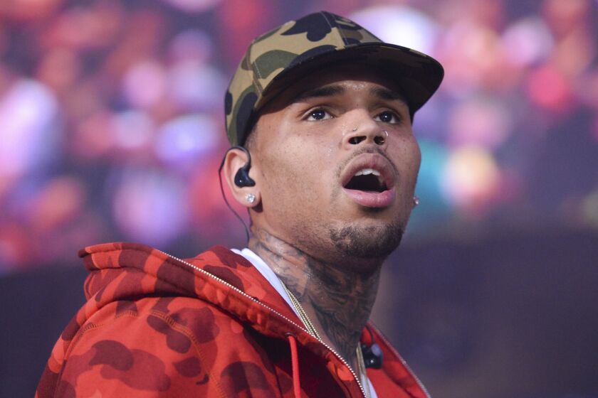 FILE - In this June 7, 2015 file photo, rapper Chris Brown performs at the 2015 Hot 97 Summer Jam at MetLife Stadium in East Rutherford, N.J. U.S. singer Chris Brown and two other people are in custody in Paris after a woman filed a rape complaint, French officials said Tuesday Jan.22, 2019. (Photo by Scott Roth/Invision/AP, File)