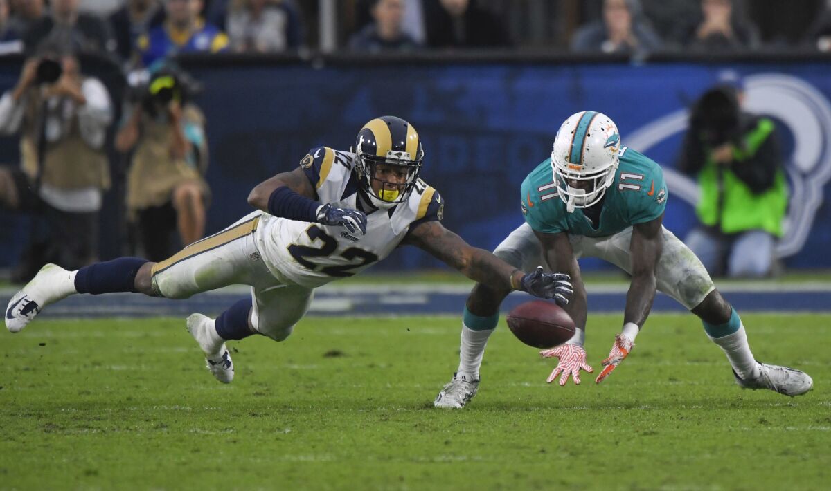 Dolphins wide receiver DeVante Parker catches a pass under pressure by Rams cornerback Trumaine Johnson during the second half on Nov. 20.