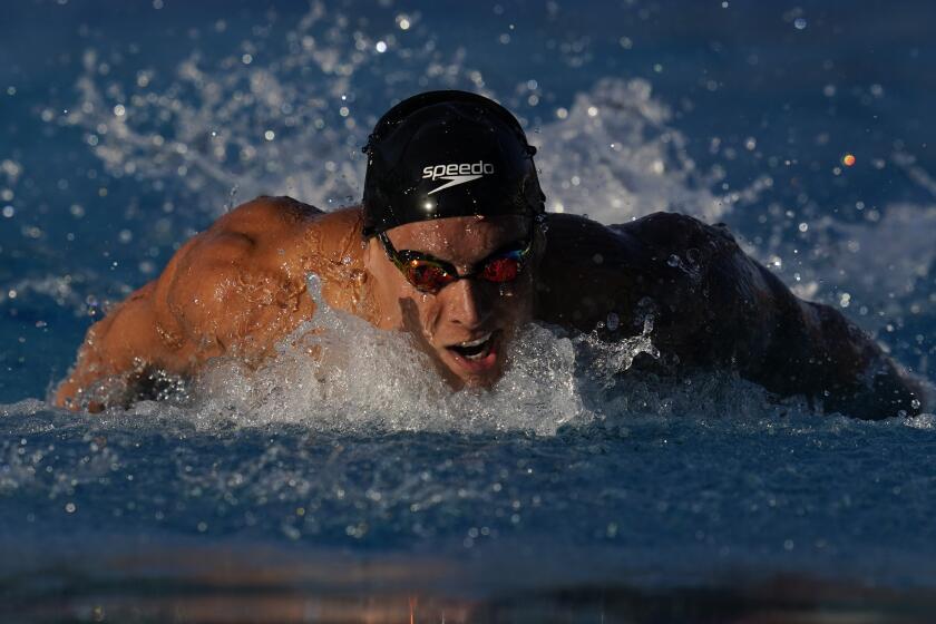 Caeleb Dressel competes in the men's 100-meter butterfly preliminary.