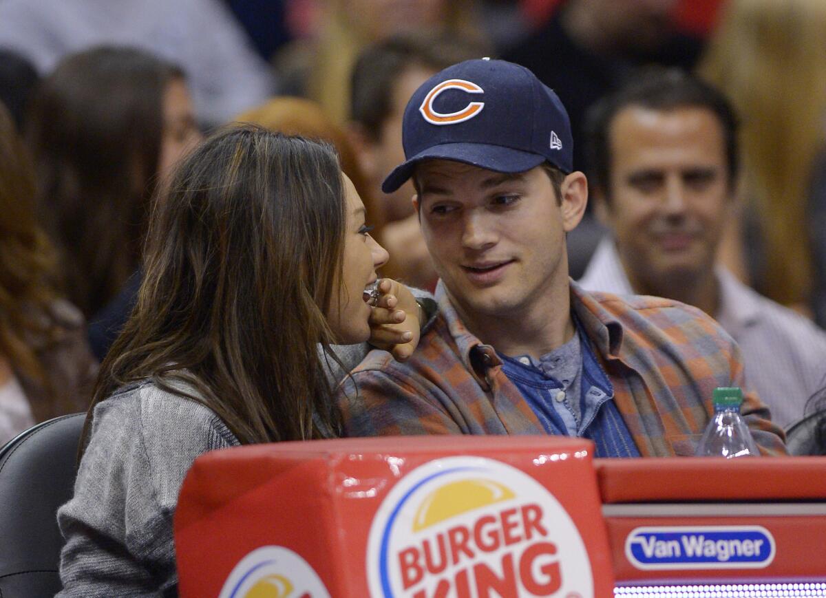 Mila Kunis and Ashton Kutcher watch the Los Angeles Clippers play the Detroit Pistons in L.A.