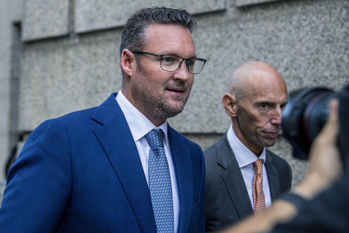 Trevor Milton, left, leaves the Thurgood Marshall United States Courthouse, Sept. 12, 2022, in New York. 