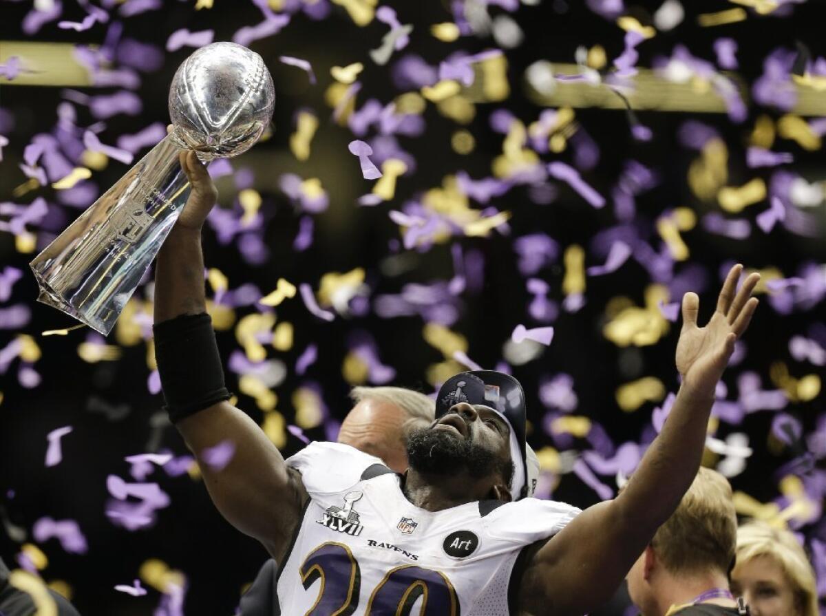 Baltimore Ravens safety Ed Reed celebrates with the Vince Lombardi Trophy after the team's 34-31 win against the San Francisco 49ers in Super Bowl XLVII.