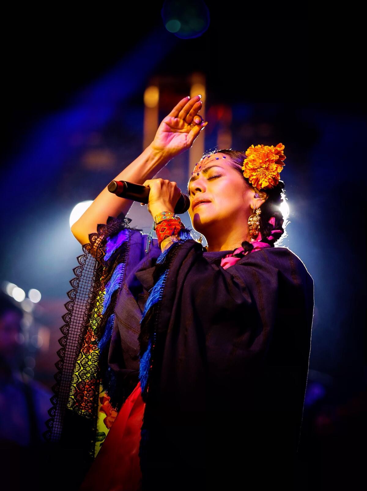 Lila Downs performs with a microphone