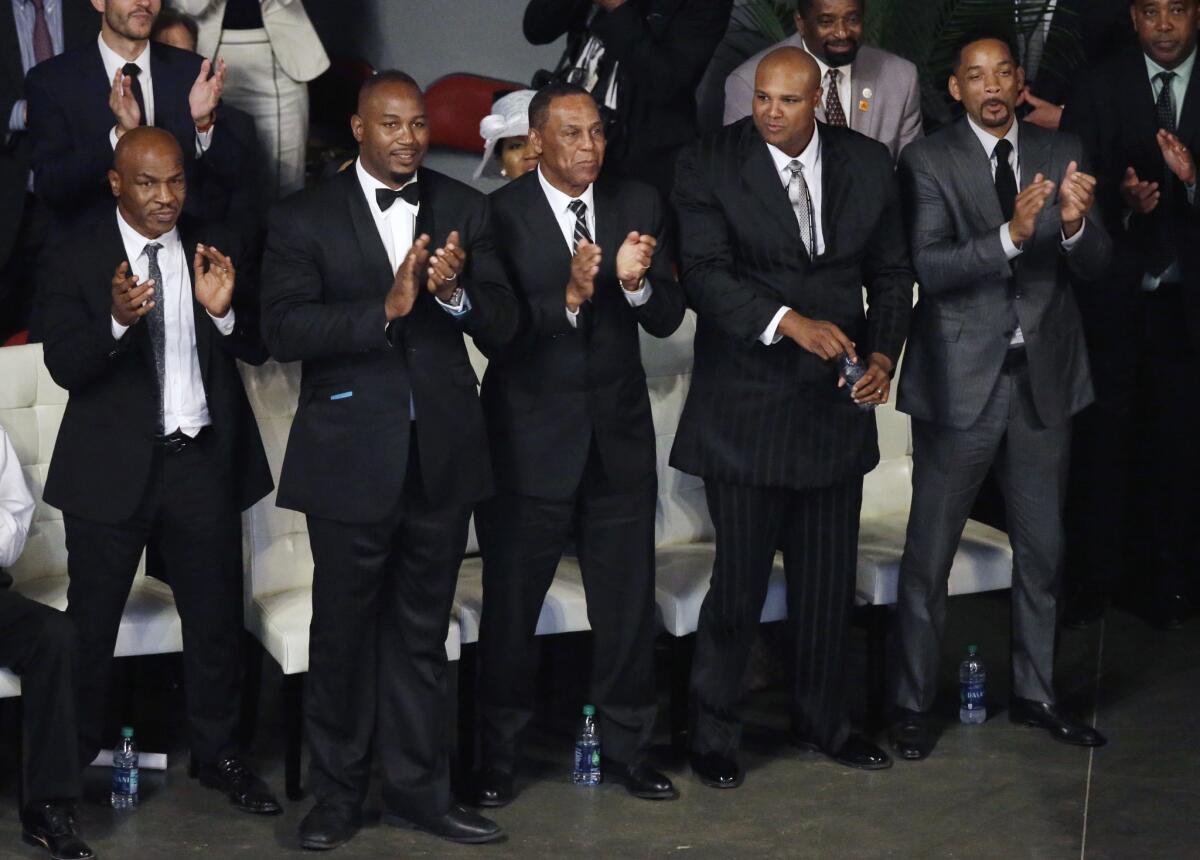 Pallbearers (from left) Mike Tyson, Lennox Lewis, Jerry Ellis, Mike Moorer and Will Smith stand during Muhammad Ali's memorial service Friday in Louisville, Ky.