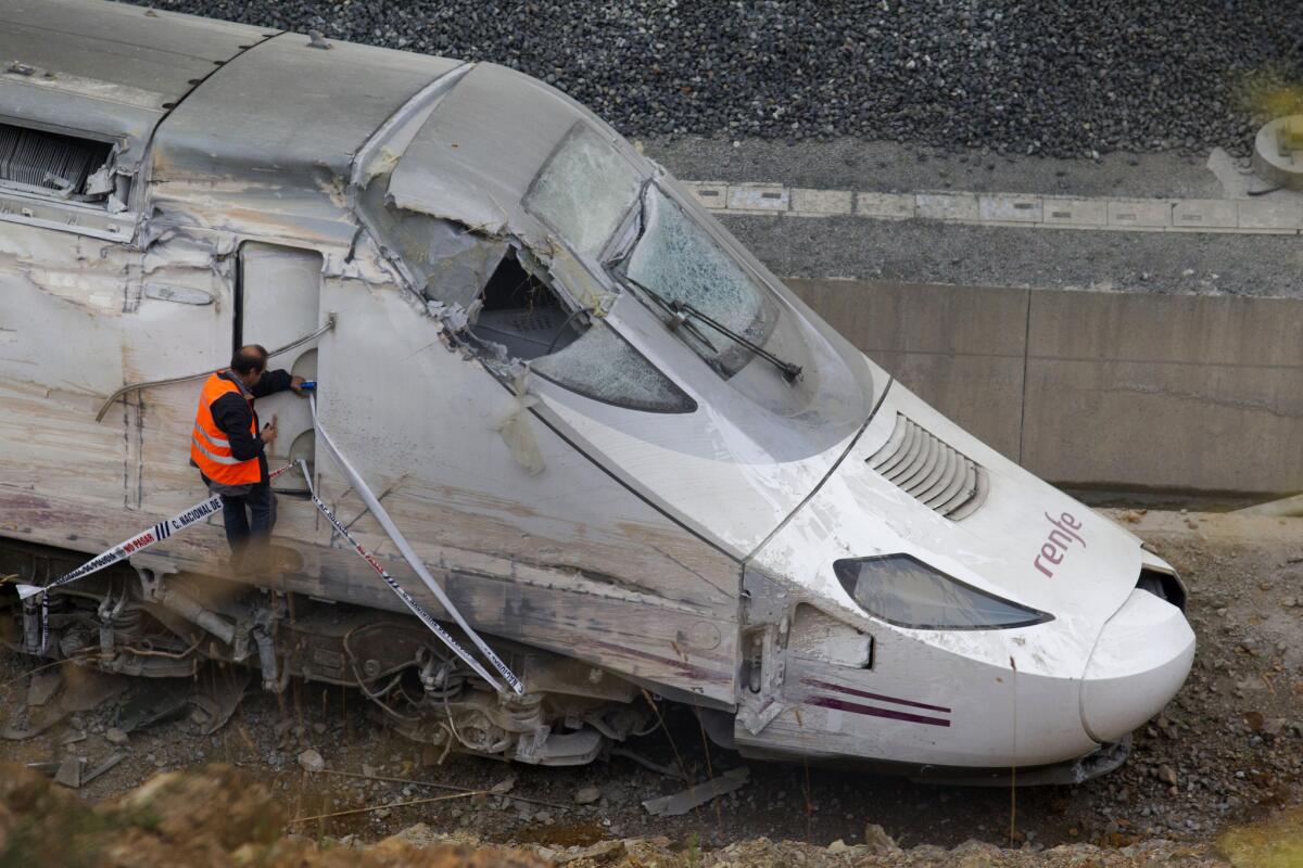 A Spanish rail worker checks the cabin of a derailed train Thursday in Santiago de Compostela.