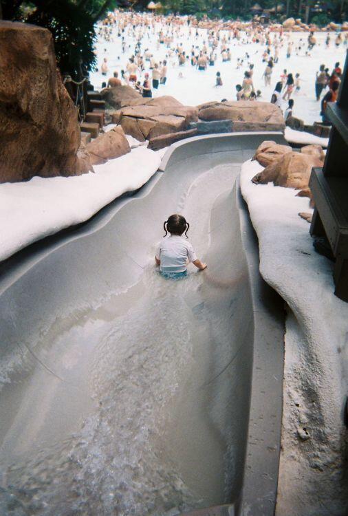 A child goes down a Bay Slide into the surf pool at Typhoon Lagoon at Walt Disney World.