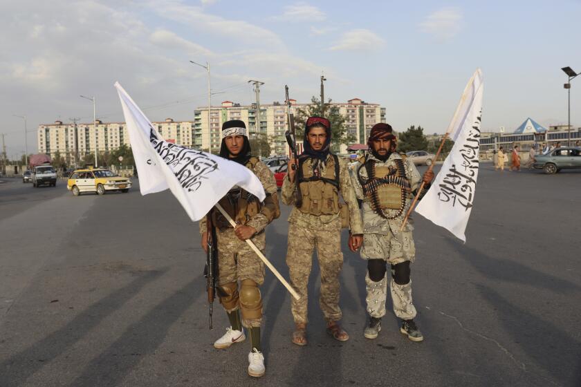 Taliban fighters hold Taliban flags in Kabul, Afghanistan, Monday, Aug. 30, 2021. Many Afghans are anxious about the Taliban rule and are figuring out ways to get out of Afghanistan. But it's the financial desperation that seems to hang heavy over the city. (AP Photo/Khwaja Tawfiq Sediqi)