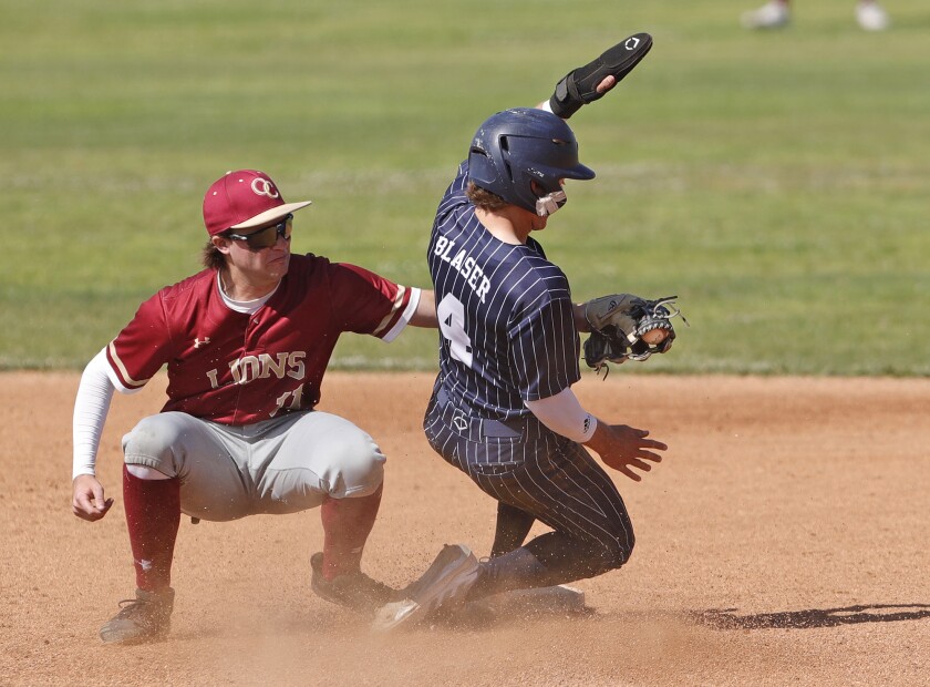 Newport Harbor's Bryce Blaser (4) is tagged out at second in a close play by Finley Buckner (11) on Tuesday.