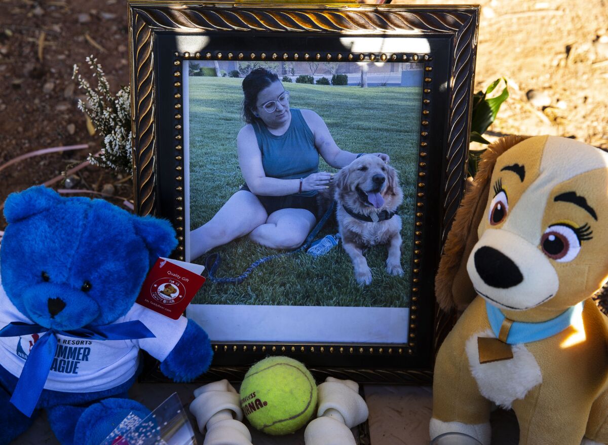 A photography of Tina Tintor, 23, and her dog is placed at a makeshift memorial site to honor them at South Rainbow Boulevard and Spring Valley Parkway, on Thursday, Nov. 4, 2021, in Las Vegas. Tintor and her dog were killed when Raiders wide receiver Henry Ruggs, accused of DUI, slammed into the rear of Tintor's vehicle. (Bizuayehu Tesfaye/Las Vegas Review-Journal)