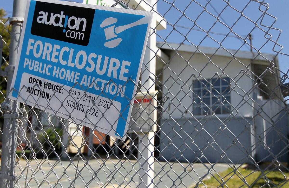 A foreclosure sign hangs on a fence in front of a foreclosed home in Richmond in 2011. (Photo by Justin Sullivan/Getty Images)